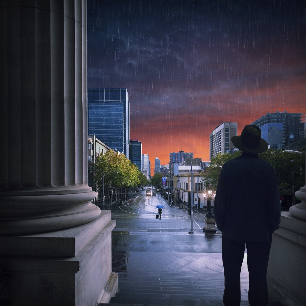 Man Overlooking Rainy City by Adrian Donoghue — canvas wall art