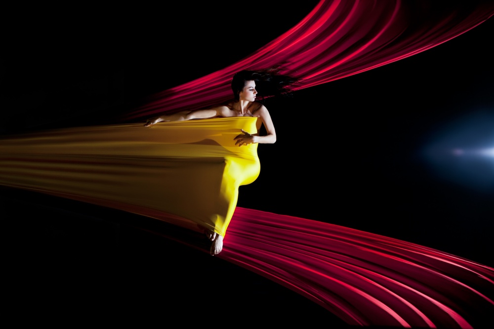 Woman In Flowing Yellow by Łukasz Kozłowski — canvas wall art