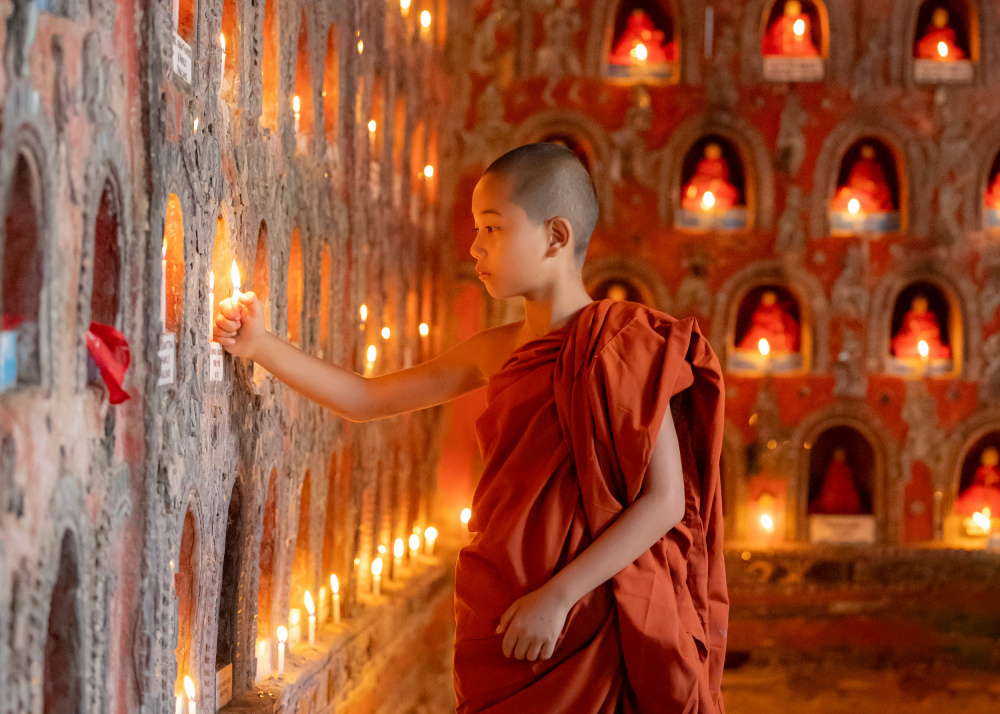 Young Monk Lighting Candles by ADIREK M — canvas wall art