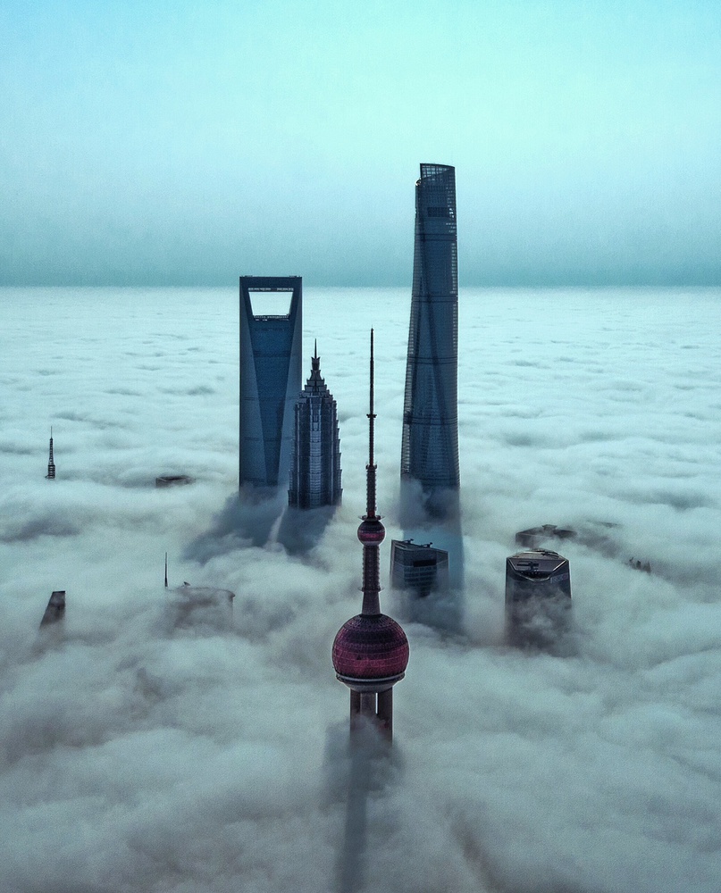 Skyscrapers Above Clouds by Stan Huang — canvas wall art