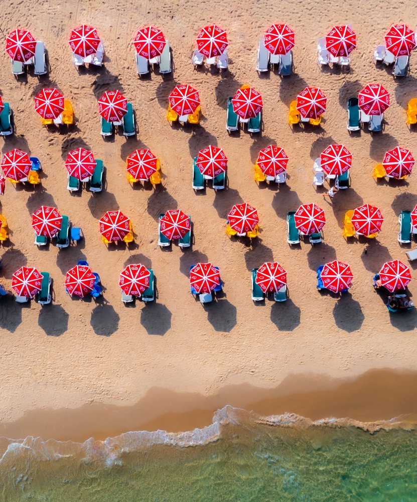 Red Umbrellas Beach Day by Gilad Topaz — canvas wall art