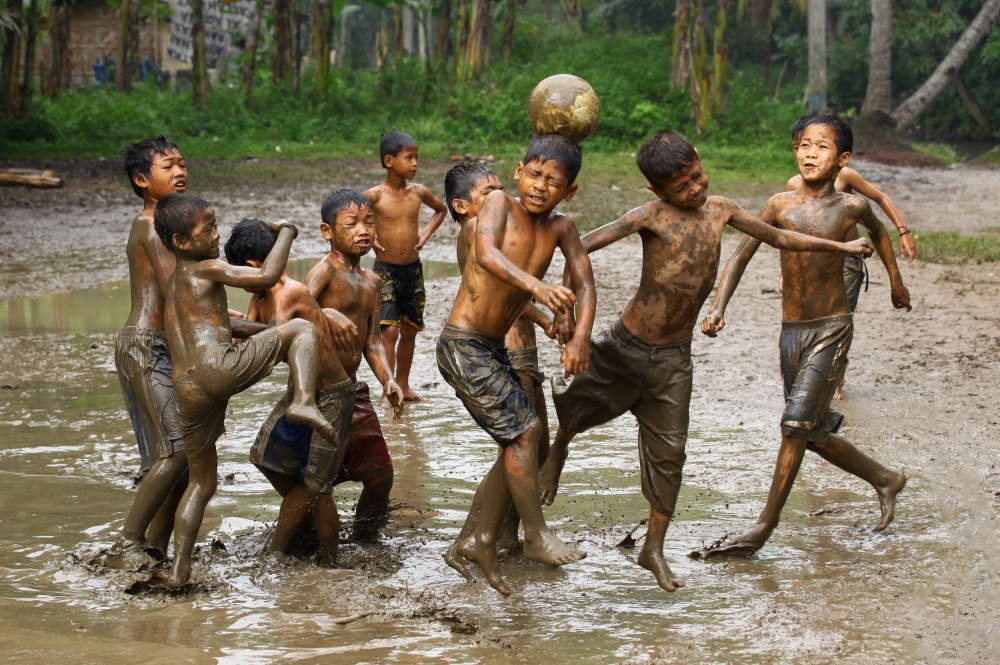 Kids Mud Soccer by Angela Muliani Hartojo — canvas wall art