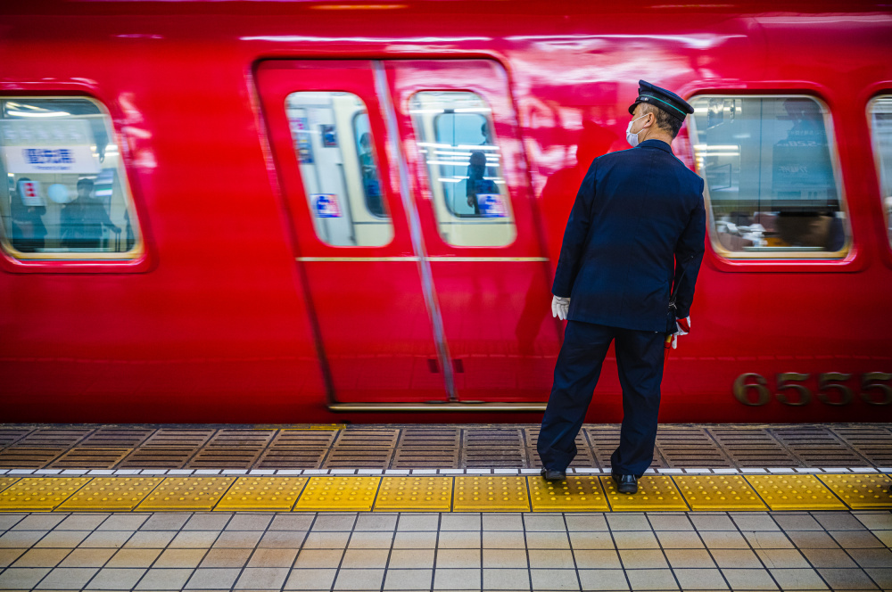 Red Train Conductor by Alan Kwang — canvas wall art