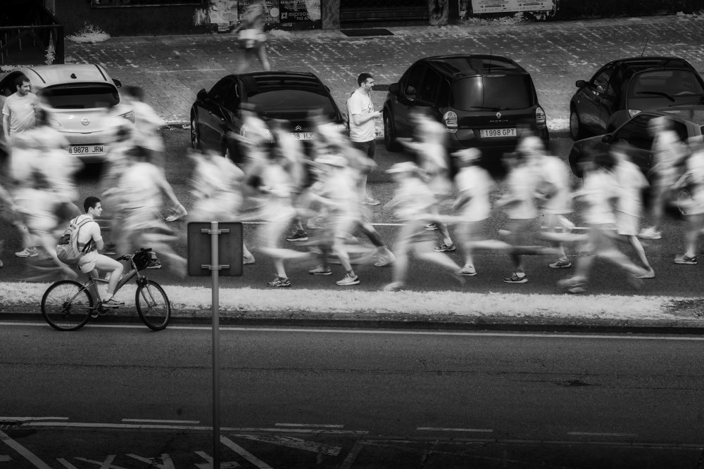 Still Cyclist Busy Street by Jesus Concepcion Alvarado — canvas wall art