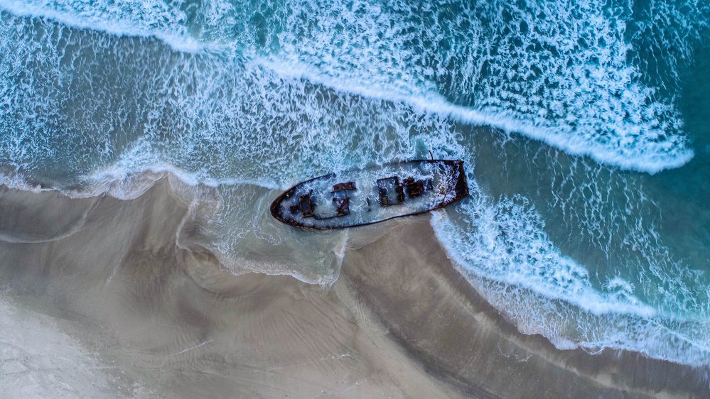 Shipwreck On Ocean Beach by Farid Kazamil — canvas wall art