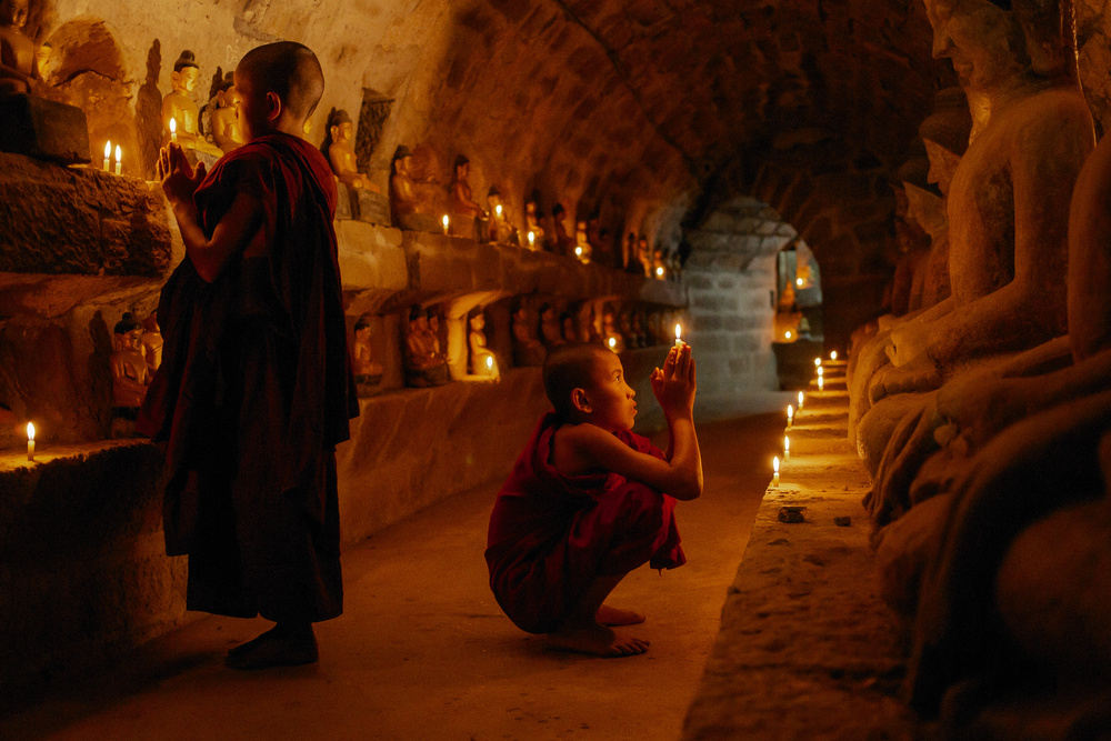 Monks in Candlelight Prayer by ADIREK M — canvas wall art