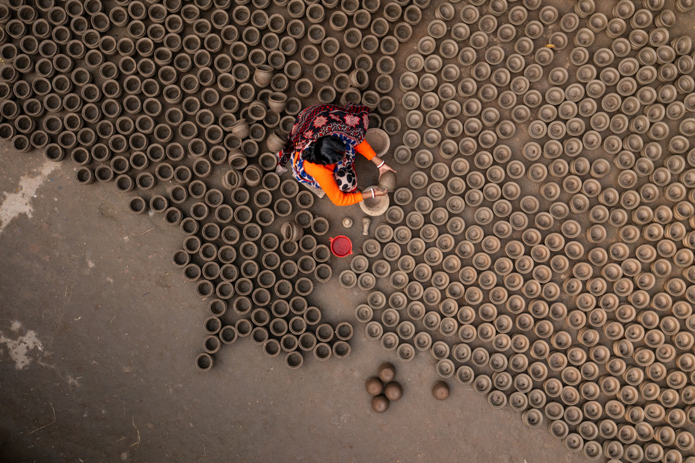 Artisan Arranging Pots by Azim Khan Ronnie — canvas wall art