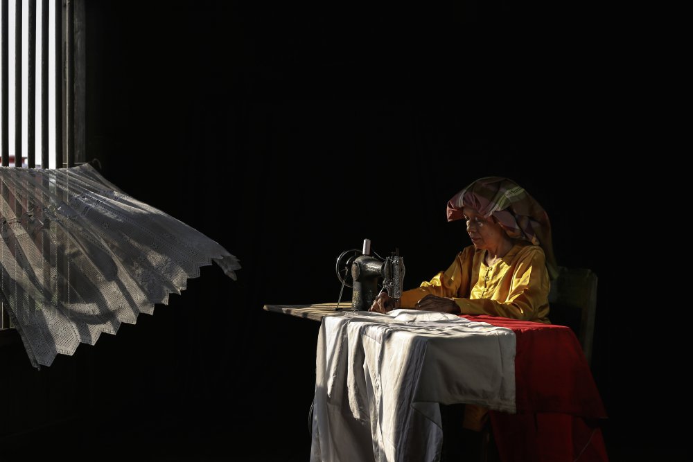 Artisan Seamstress at Work by Insan Kamil — canvas wall art