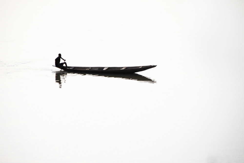 Lone Boatman Reflection by Florent Dirk Thies — canvas wall art