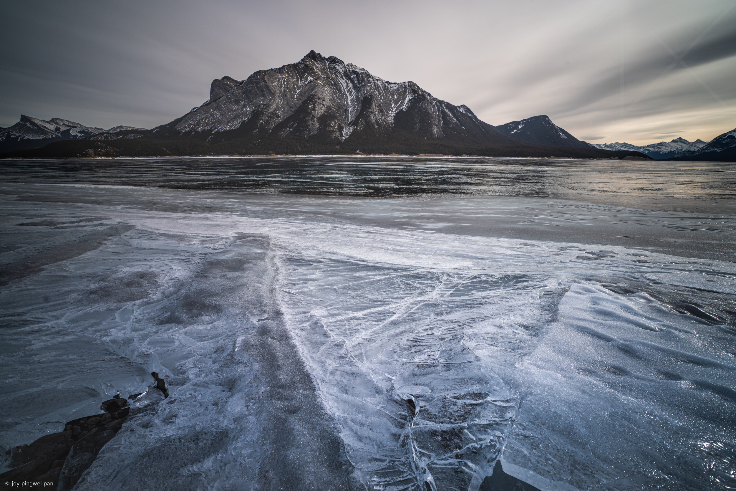 Wind-Sculpted Ice Patterns on Frozen Lake in Banff NP by joy pingwei pan