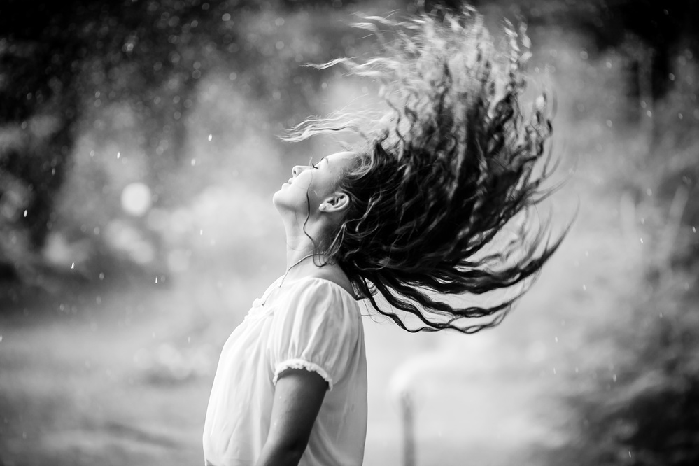 Joyful Hair Flip In Rain by Evelina Petkova — canvas wall art