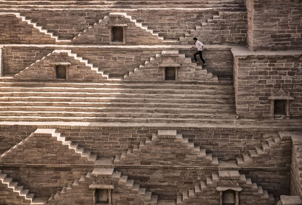 Man Climbing Indian Stepwell by Andrei Nicolas - The Traveler — canvas wall art