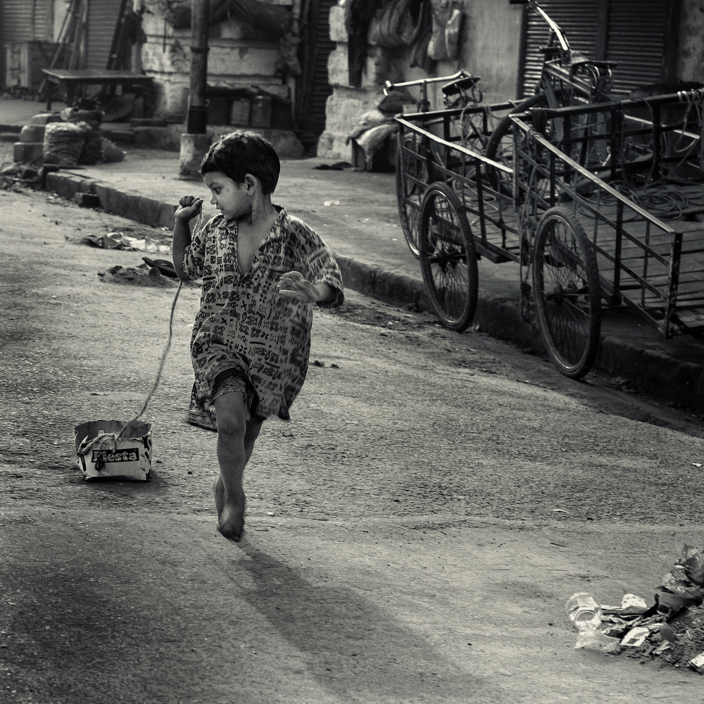 Street Child with Pull Toy by Thomas Siegel — canvas wall art