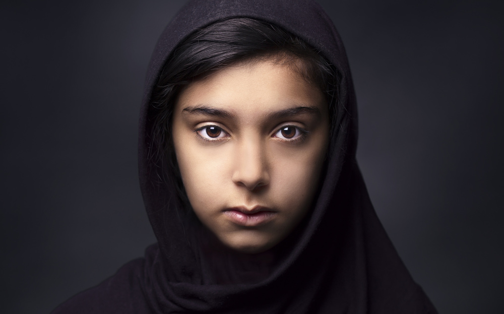 Hooded Girl Intense Gaze by Fadhel — canvas wall art