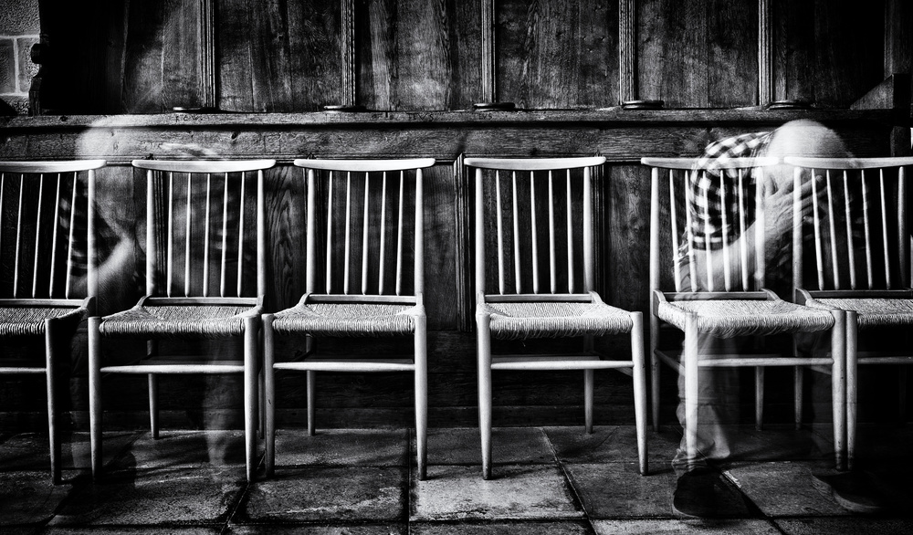 Blurred Figures Empty Chairs by Jürgen Hartlieb — canvas wall art