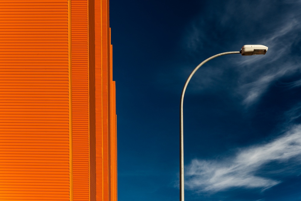 Orange Building Blue Sky by E. de Juan — canvas wall art