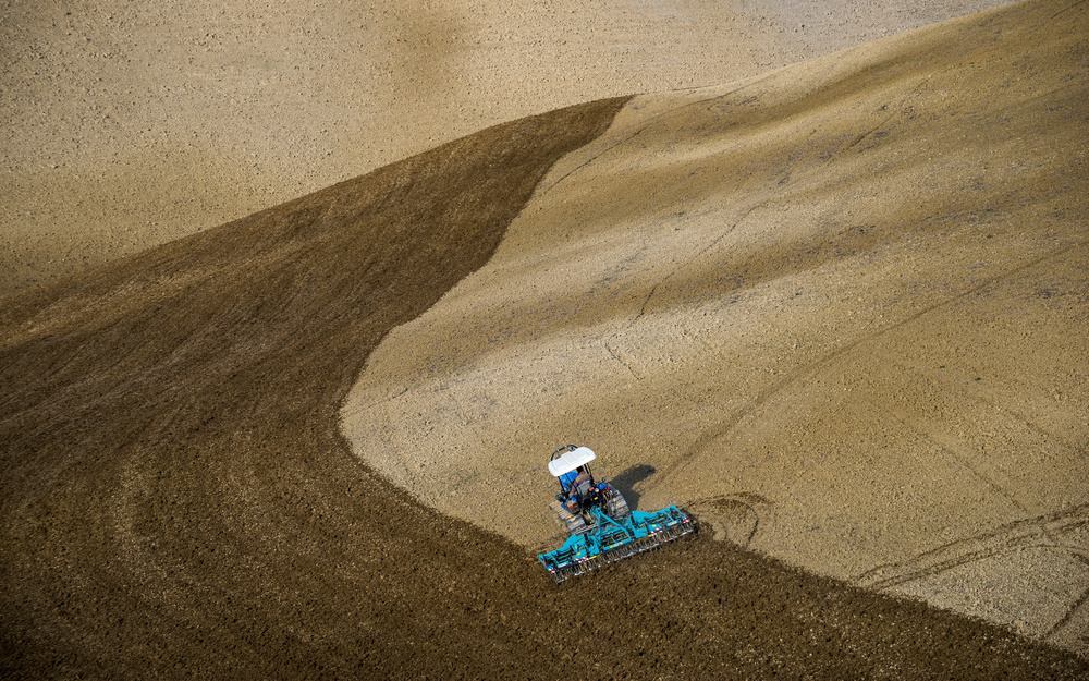 Tractor Plowing Field by Riccardo Lucidi — canvas wall art