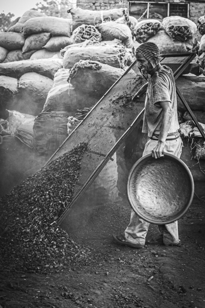 Man Sifting Charcoal by Alan Kwang — canvas wall art