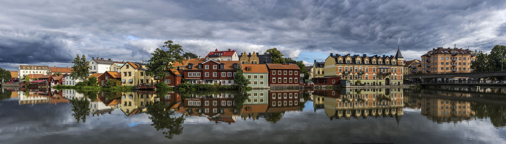 Colorful River Town Reflections by Arne Östlund — canvas wall art