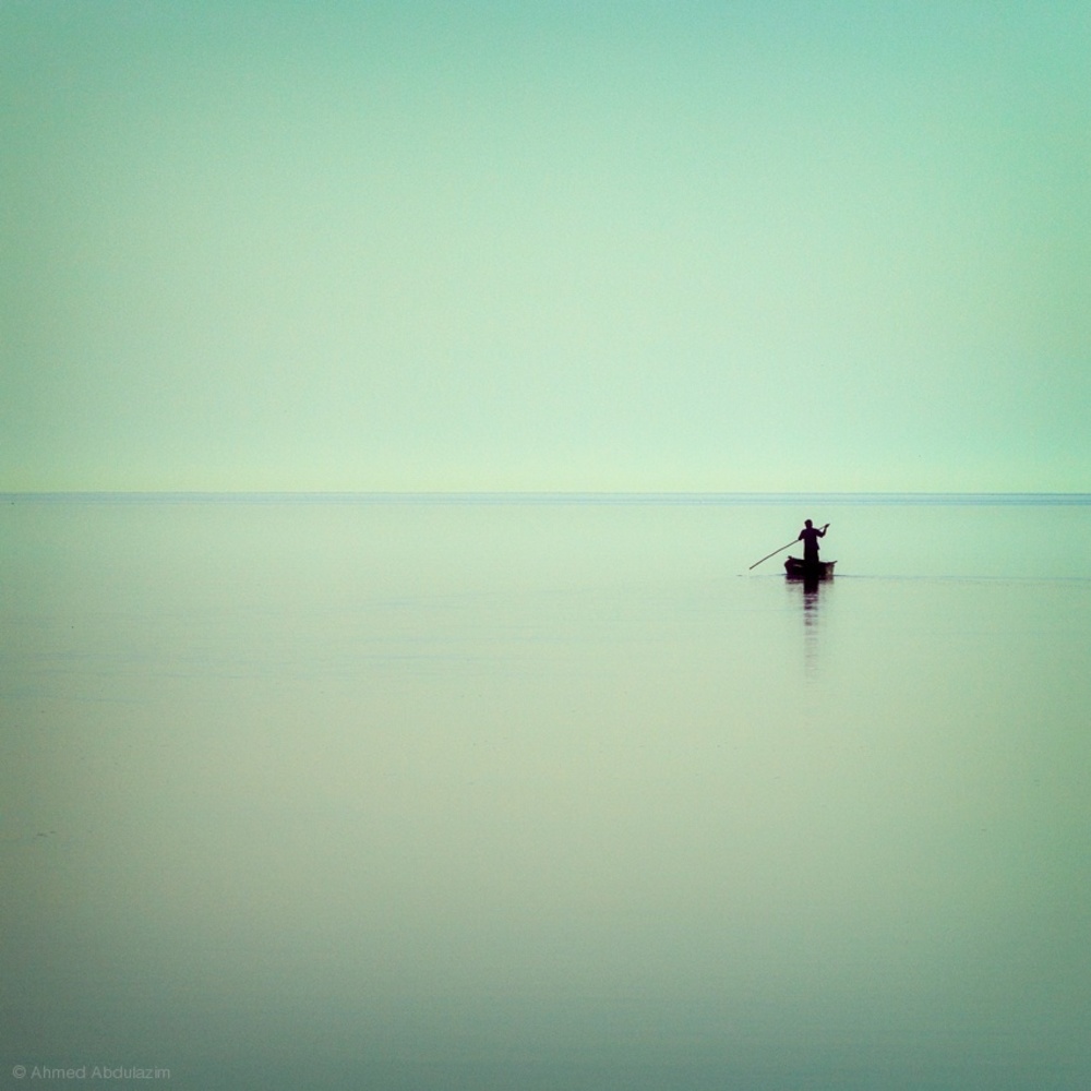 Lone Boat on Calm Water by Ahmed Abdulazim — canvas wall art