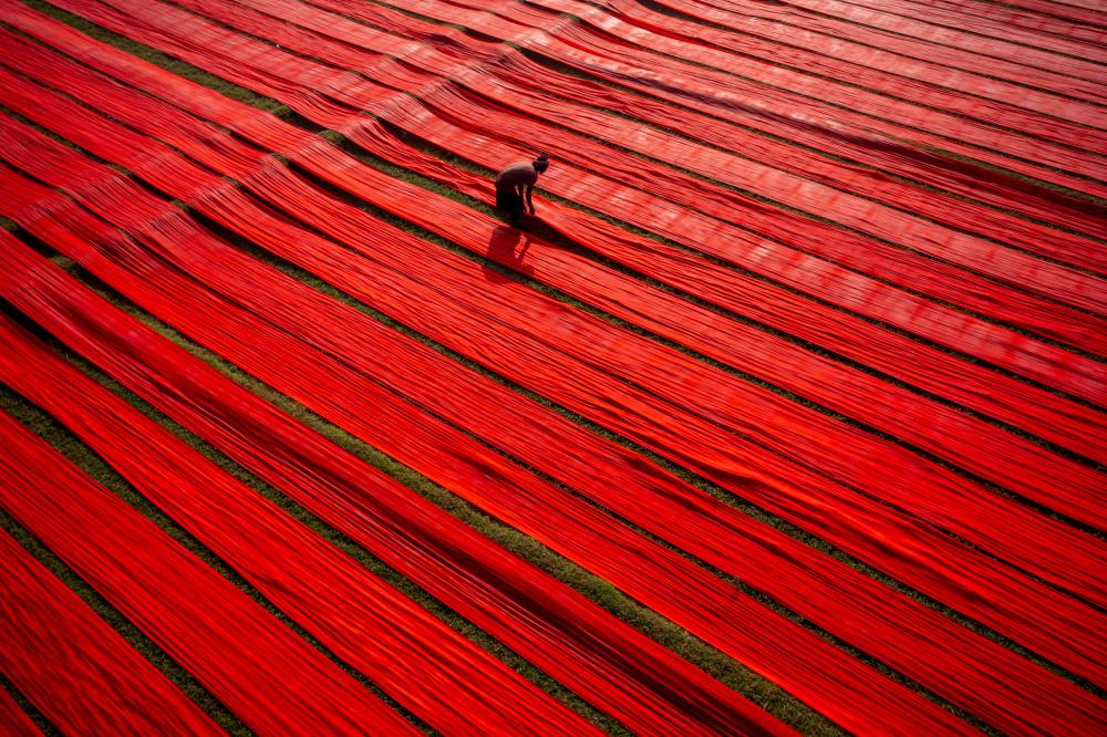 Red Fabric Worker by Azim Khan Ronnie — canvas wall art