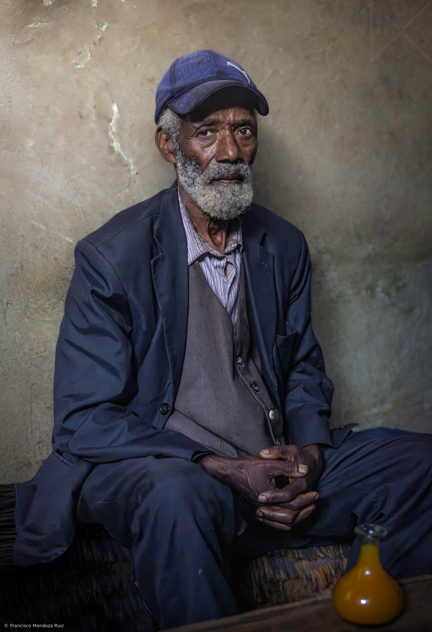 Dorze old man portrait drinking at a tavern, Ethiopia