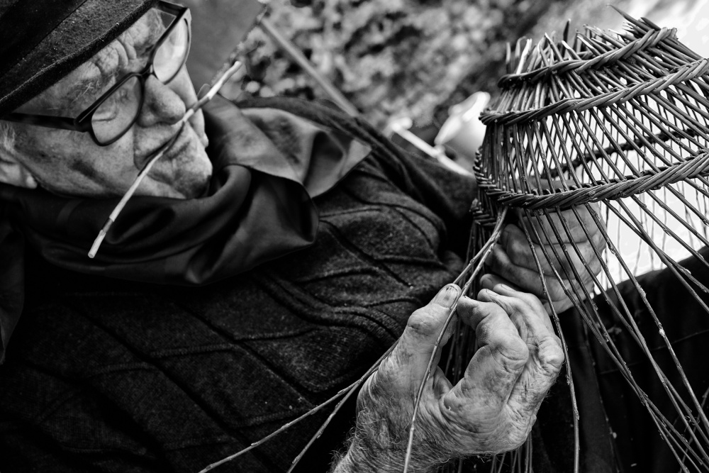Focused Man Weaving Basket by Manu Allicot — canvas wall art