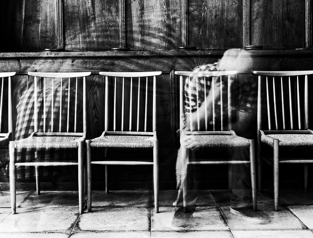 Ghostly Figure Among Chairs by Jürgen Hartlieb — canvas wall art
