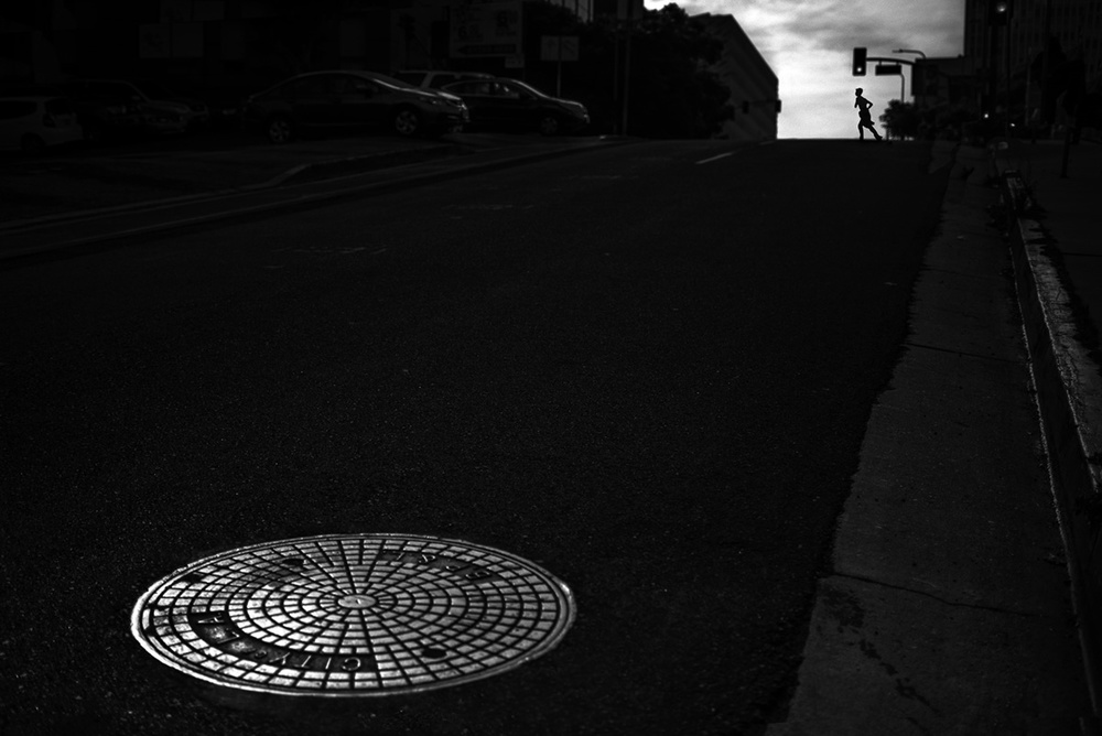 Manhole and City Silhouette by Tina Kim — canvas wall art