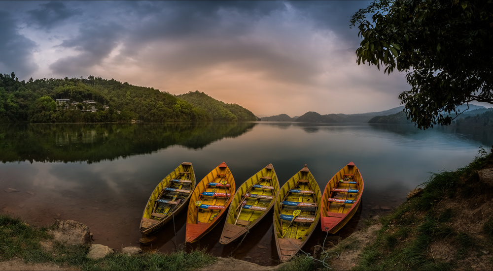 Colorful Boats on Serene Lake by Khalid Jamal — canvas wall art