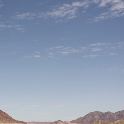 Vast Desert Road Under A Clear Blue Sky