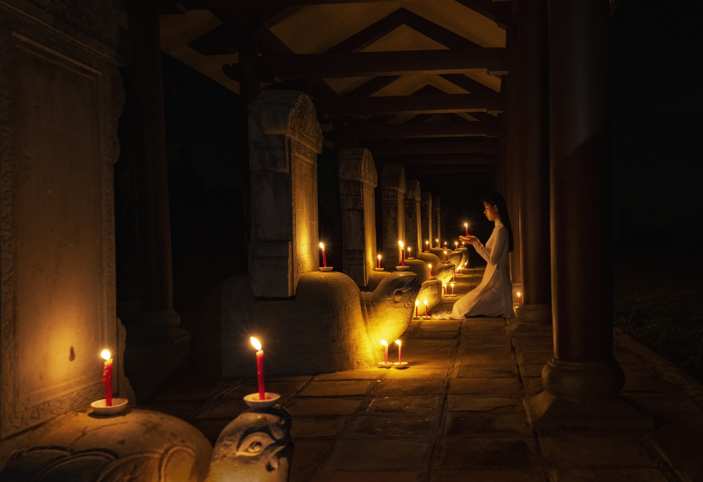 Woman in Candlelit Temple by Handi Nugraha — canvas wall art