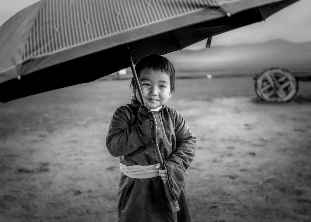 Smiling Boy Under Umbrella by ADIREK M — canvas wall art