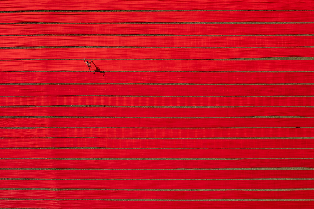 Red Field Lone Figure by Azim Khan Ronnie — canvas wall art