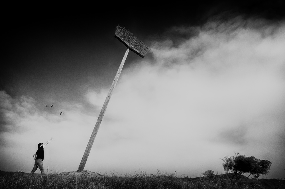 Man and Giant Broom by Miki Meir Levi — canvas wall art